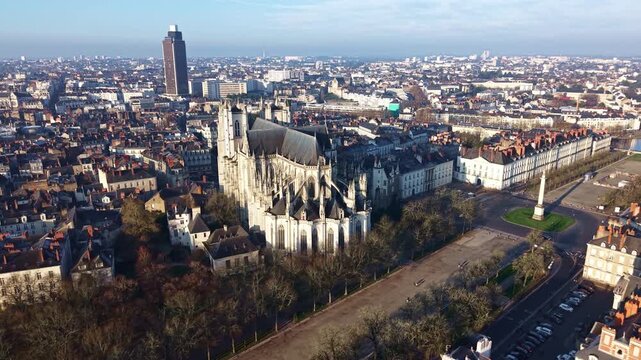 Wide aerial view of Nantes cityscape, featuring Cathedral of Saint Pierre or St Peter and Saint Paul, Place Mar&eacute;chal Foch, and Tour de Bretagne in Nantes, France
