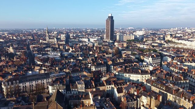 Nantes cityscape, with the Cathedral and Tour de Bretagne skyscraper defining the city skyline in Nantes, France. Aerial drone forward
