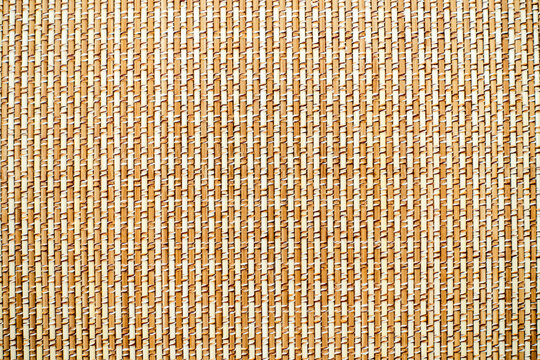 The surface of the mat is woven from light brown fine bamboo.