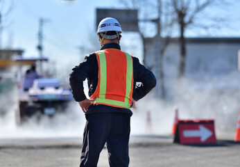 街路舗装工事を監督する工事部長