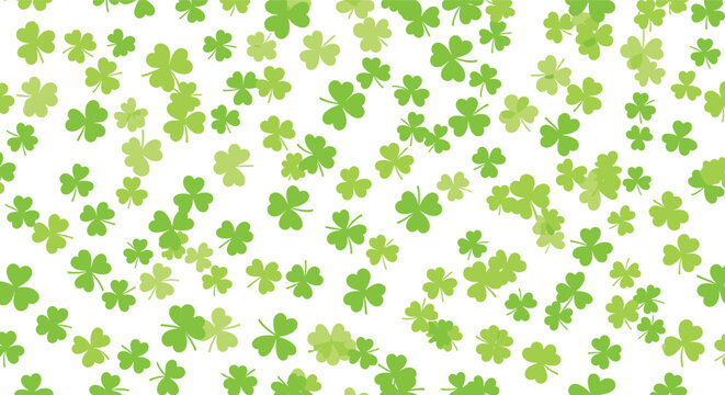 Festive pattern of scattered green clovers of various sizes on a white background for Saint Patricks Day celebration.