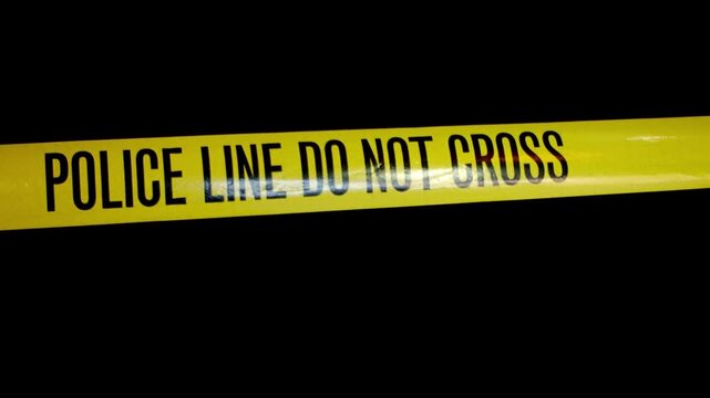 A 4K stock video of a police line cordon tape. Filmed at 4K.