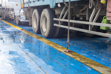 Cargo Securing Ratchet Strap Fixing a Heavy Truck to a Ferry Ship Deck