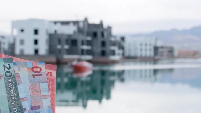 Jordanian dinar banknotes in hand, economy finance cash concept, real estate investment background. Ayla. Holidays in Jordan, red sea vacation, property purchase, israel border zone concept