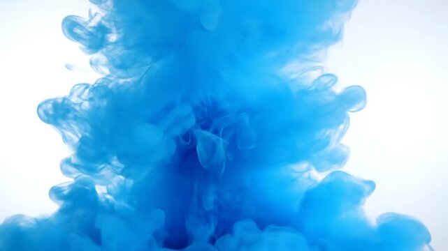 Vibrant blue ink swirling and spreading dynamically in clear water on a white background.