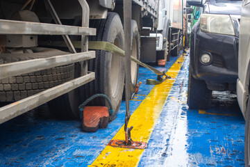 Cargo Securing Ratchet Strap Fixing a Heavy Truck to a Ferry Ship Deck