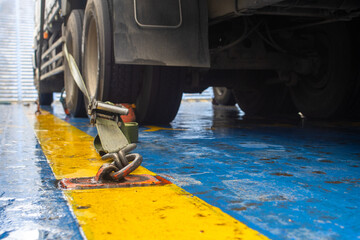Cargo Securing Ratchet Strap Fixing a Heavy Truck to a Ferry Ship Deck