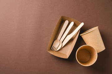 Eco takeaway packaging with wooden cutlery and paper cups