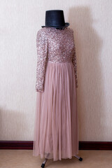 A beautiful women's dress on a mannequin with a hat