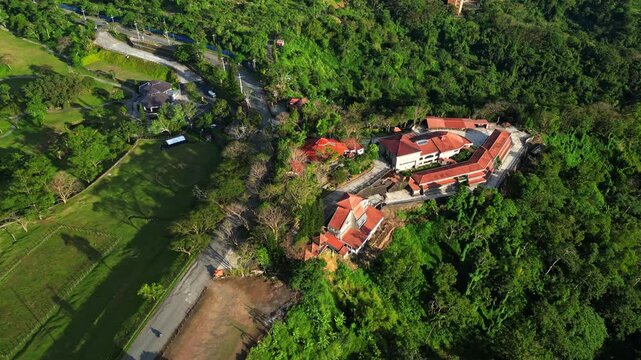 Elevated overlook revealing chapel grounds, rolling mountains, and thriving farmland scener of Don Bosco Chapel of the Hill Batulao Nasugbo Batangas Philippines