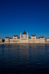 Obraz premium Travel destination in Hungary. Panorama of Budapest with Danube and Parliament. Gothic architectural in Budapest. Historic landmark and national symbol of Hungary on Danube.
