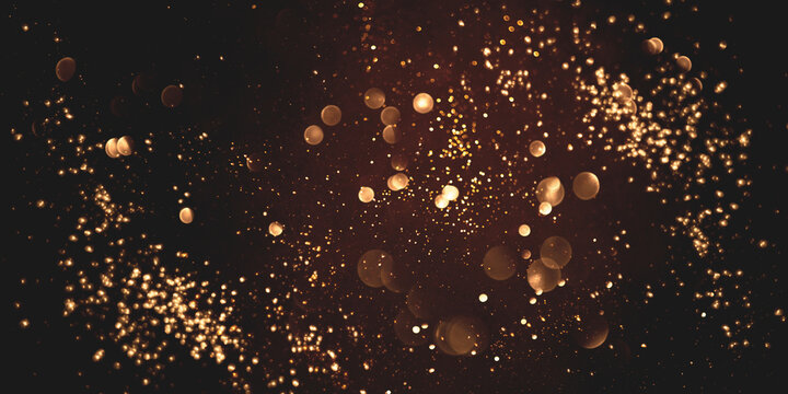 Golden abstract bokeh on black background. Holiday concept