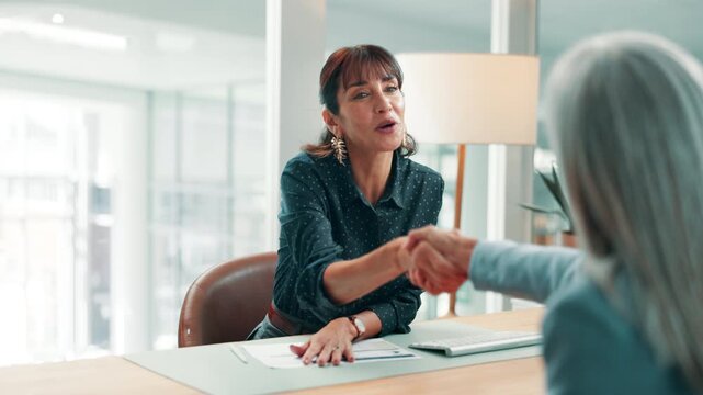 Handshake, interview and meeting with business women in office together for onboarding success. Deal, human resources and recruitment with employee people shaking hands at work for job opportunity