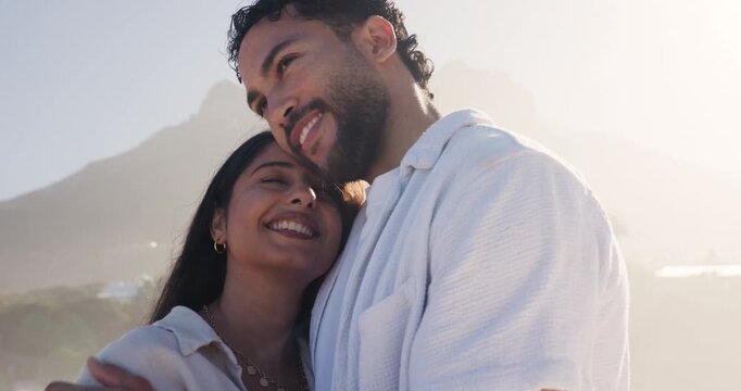 Beach, hug and couple on break, laughing and bonding on summer holiday, love or romance with partner. Outdoor, man and embrace with woman on vacation, happiness and commitment for relationship at sea
