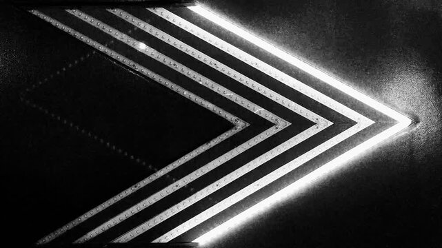 Abstract neon glowing arrow chevron on industrial metal texture with rivets background for direction and technology concept.