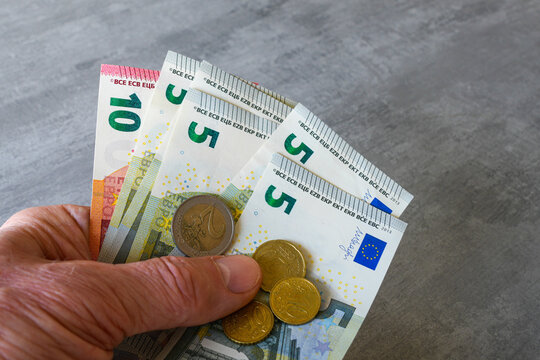 Hand Holding Euro Banknotes and Coins Close Up European Money and Finance Concept