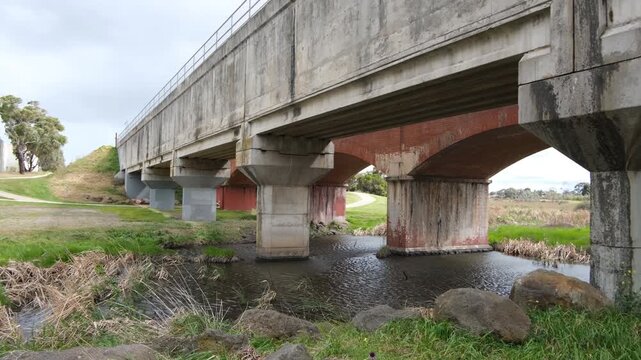 Concrete viaduct over Skeleton Creek and wetlands in suburban Melbourne, Australia, forming part of a sewage or wastewater management system, civil engineering infrastructure