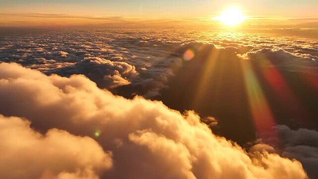 Golden Sunrise Over Fluffy Clouds from Above, Aerial View, Sunbeams