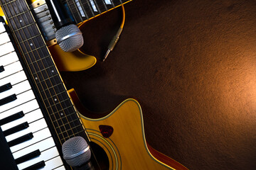 Music banner with acoustic guitar, electric guitar, piano keyboard and microphones with copy space. Band instruments composition background. © DenS