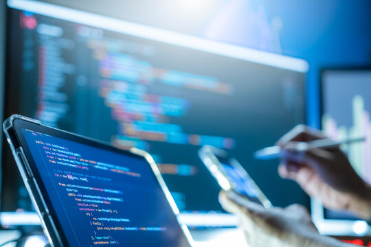 Programmers are writing computer code to develop applications or websites using JavaScript and C++ programming languages, and testing them to ensure the system works efficiently on their smartphones.