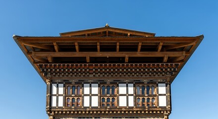 Traditional Bhutanese Architecture with Intricate Wooden Details Against Blue Sky.