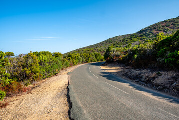 Naklejka premium Empty road through hilly landscape