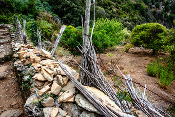 Fototapeta premium Stone Wall and Wooden Fence in Hillside