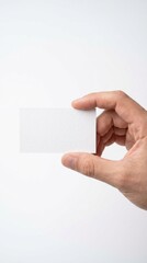 Fototapeta premium Hand holding a blank white business card on white background