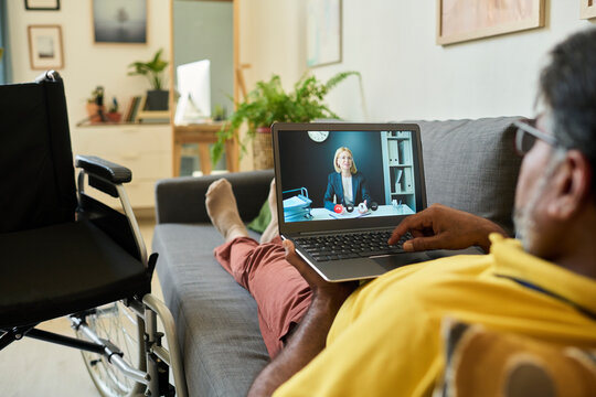 Employee with disability having online interview with manager on laptop