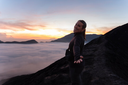 Traveler hiking near volcano crater in Java Indonesia at sunrise