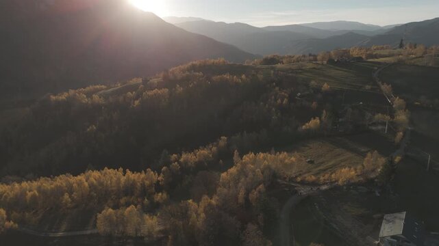Poetic Aerial Pull Back Over Golden Autumn Valleys Towards the Sunset as the Season Ends in Poiana Marului Cinematic 4K Ungraded Log