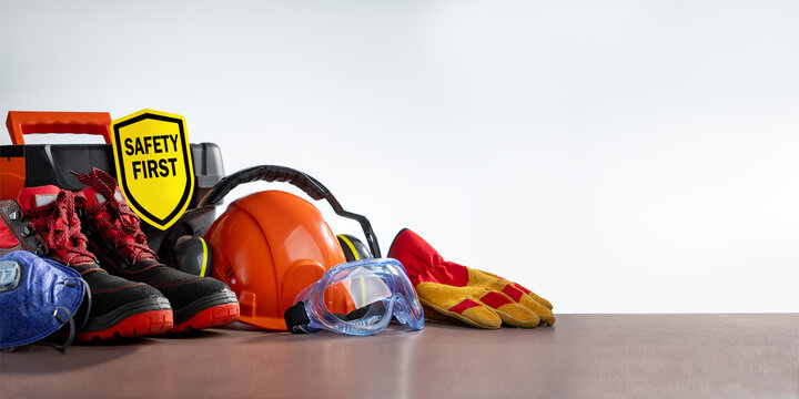 Work safety protection equipment on grey background with copy space. Horizontal banner.