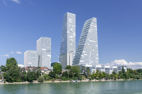 Basel, Switzerland - August 16th 2024 : View on the Roche Towers, two skyscrapers built between 2012 and 2022, housing the offices of the pharmaceutical group Roche on the banks of the Rhine river.