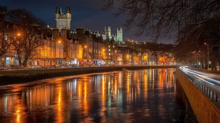 Fototapeta premium Nighttime Cityscape of Historic Buildings Along a Riverbank