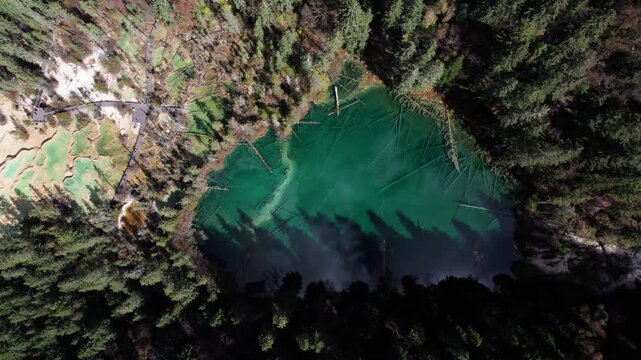 Drone view of Shenxianchi Scenic Area in Sichuan, China, near Jiuzhaigou and Huanglong, peaceful and clean water in pond among mountains, 4k real time footage travel concept.