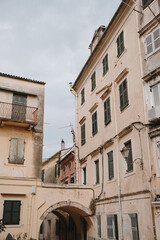 Elegant White Window with Green Shutters Framed by a Simple Wall