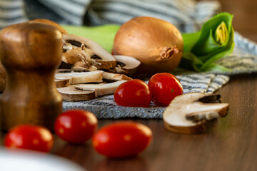 Fresh mushrooms and vegetables on rustic kitchen table
