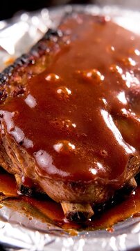 Ribs covered in barbecue sauce sizzling