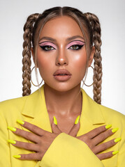 Young woman posing with braided hair and vibrant yellow outfit  