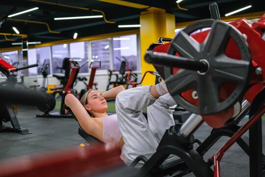 Athlete performs strength training on gym machine for muscle building