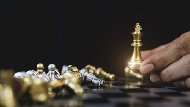 Hand chooses king chess for leadership business strategy plan or wining challenge and team player and risk management or human resource or strategic planning.