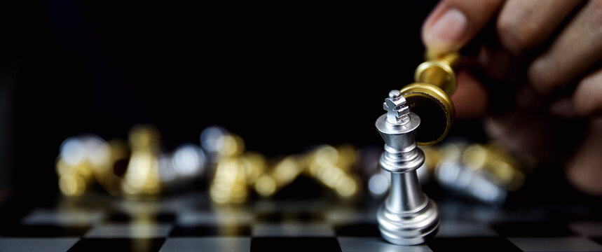 Hand chooses king chess for leadership business strategy plan or wining challenge and team player and risk management or human resource or strategic planning.