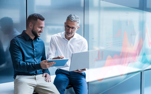Business team analyzing digital data in modern office setting