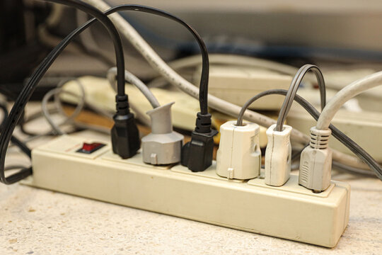 Old electrical extension cords plug is broken case damage and danger or connector voltage power burnt overload