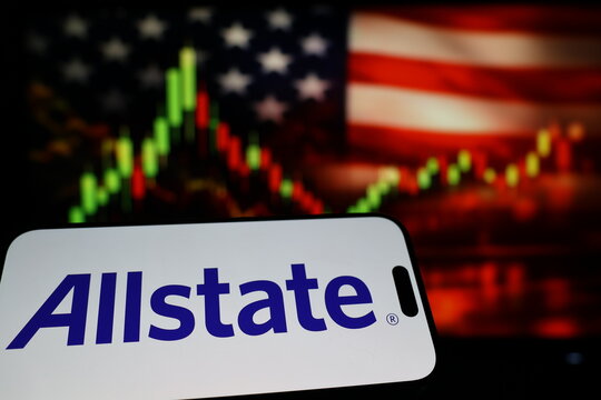 Kiel, Germany - 03-03-2026: US insurance company The Allstate Corporation logo on smartphone against US flag and rising stock market candlestick chart concept