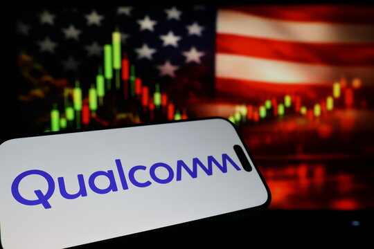 Kiel, Germany - 03-03-2026: US semiconductor company Qualcomm Incorporated logo on smartphone against US flag and rising stock market candlestick chart concept