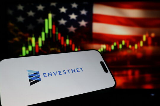 Kiel, Germany - 03-03-2026: US financial technology company Envestnet Inc. logo on smartphone against US flag and rising stock market candlestick chart concept
