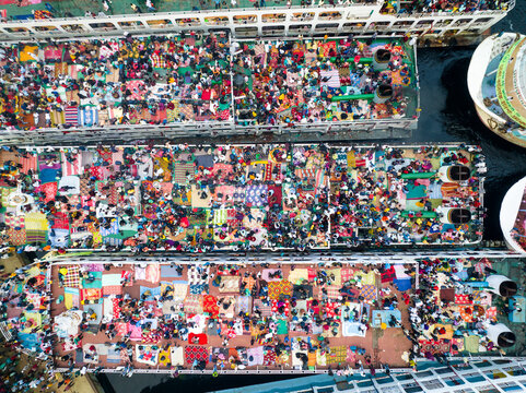 Aerial view of vibrant crowds gather atop ferries, a sea of humanity amidst the city's waterways, Dhaka, Dhaka Division, Bangladesh.