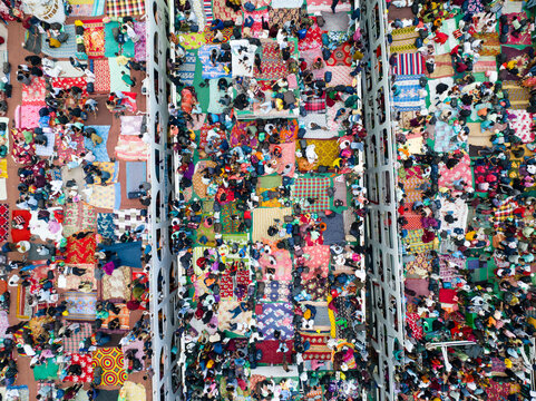 Aerial view of a sea of vibrant colors as people gather closely together, creating an intricate tapestry of humanity, Dhaka, Dhaka Division, Bangladesh.