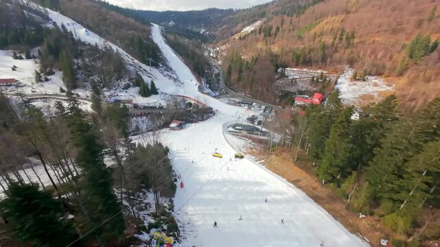 FPV perspective captured at Solisko in Szczyrk. In winter, drones follow skiers and snowboarders from above.